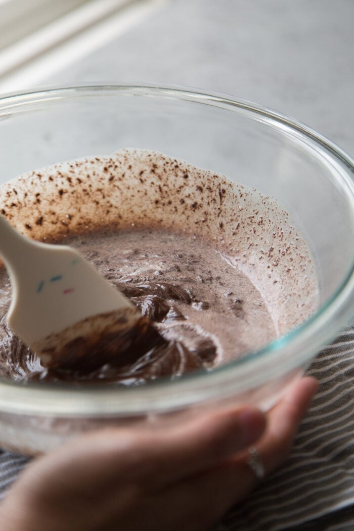 bowl of chocolate and hot cream mixed together to create ganache.