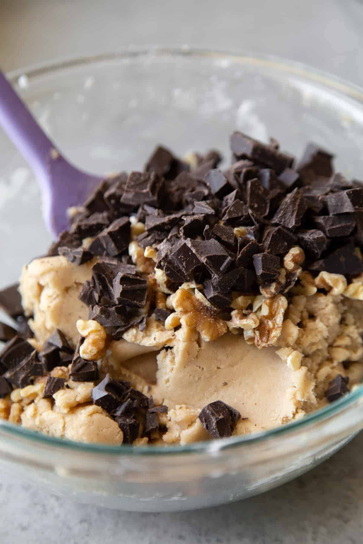 add chocolate and toasted nuts to vegan cookie dough batter.
