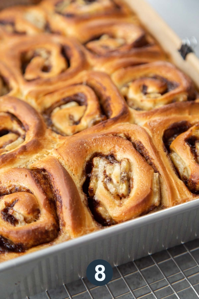 fresh baked banana cinnamon rolls in baking pan.