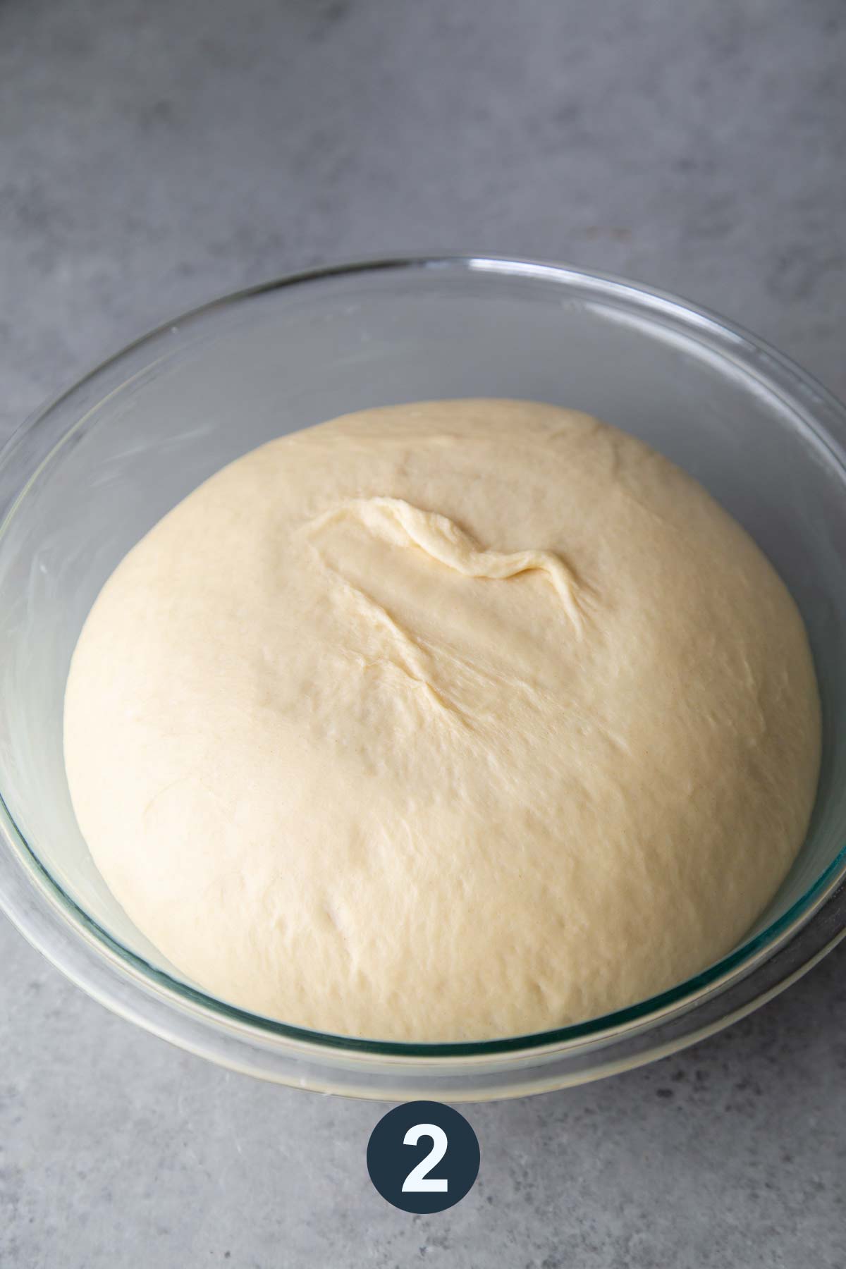 proofed cinnamon roll yeast dough in bowl.