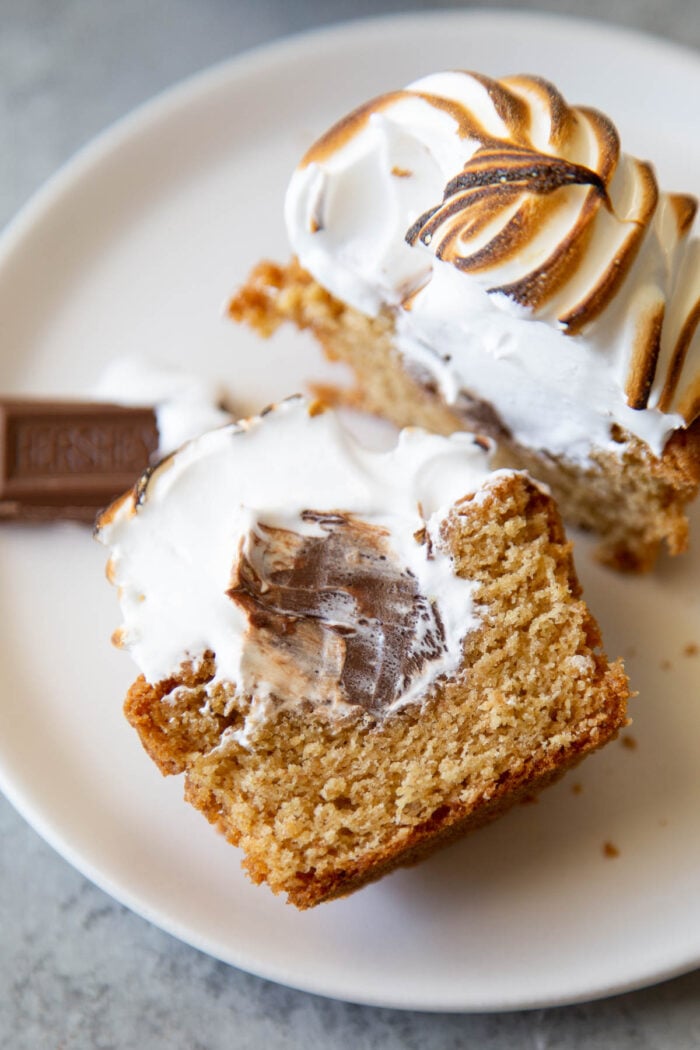 s'mores cupcake sliced in half to showcase chocolate ganache filling interior.