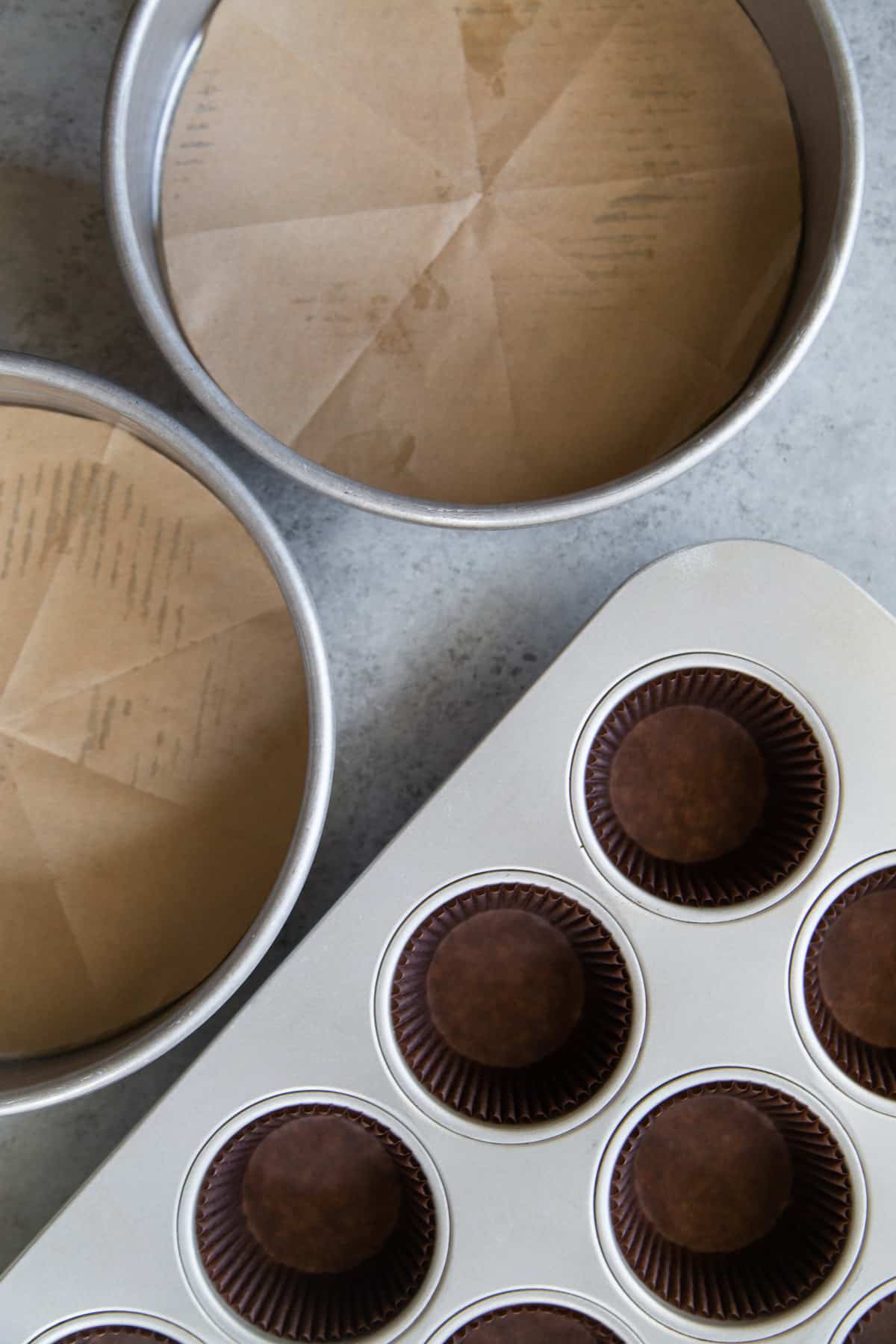 parchment lined 8-inch cake pan and lined muffin tin.