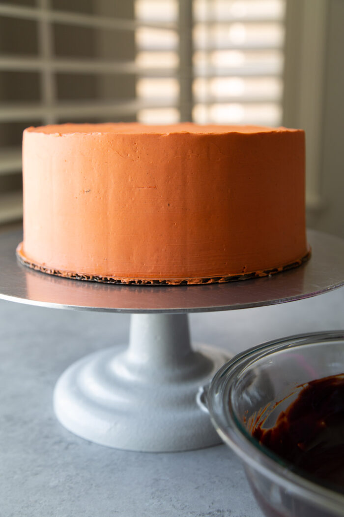chocolate pumpkin cake frosted with orange colored buttercream.