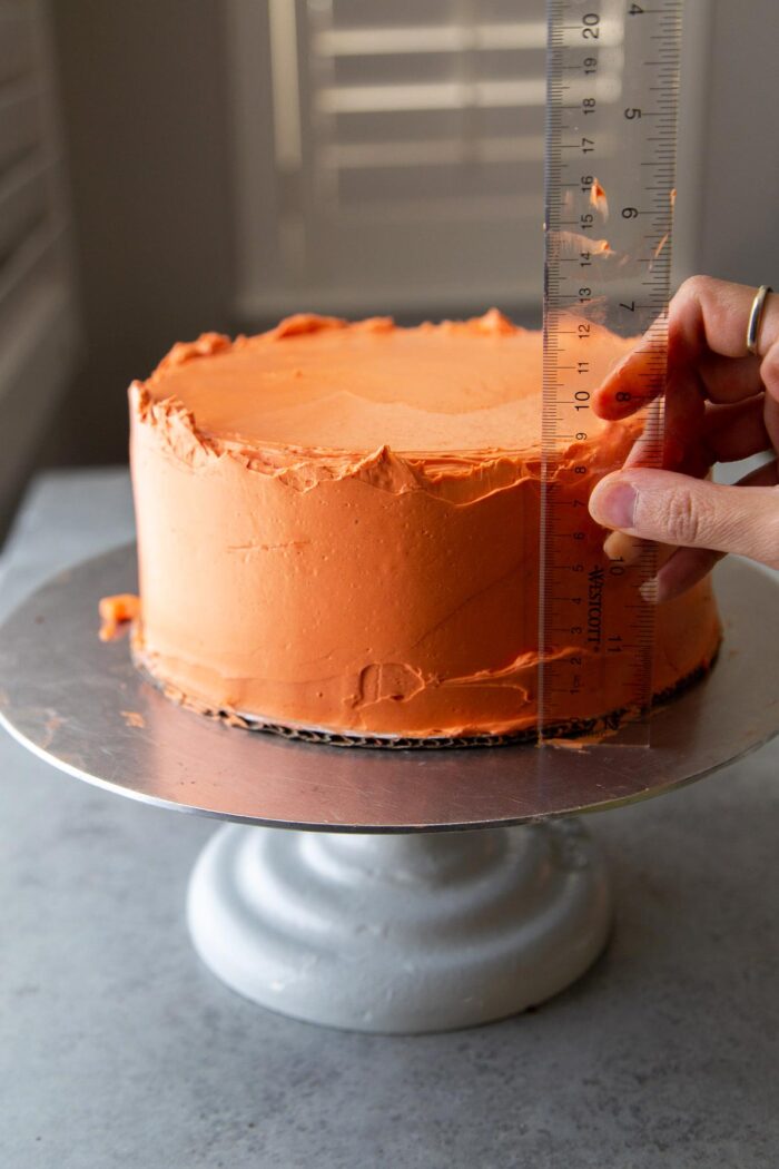 final frosting coating for two layer chocolate pumpkin cake.