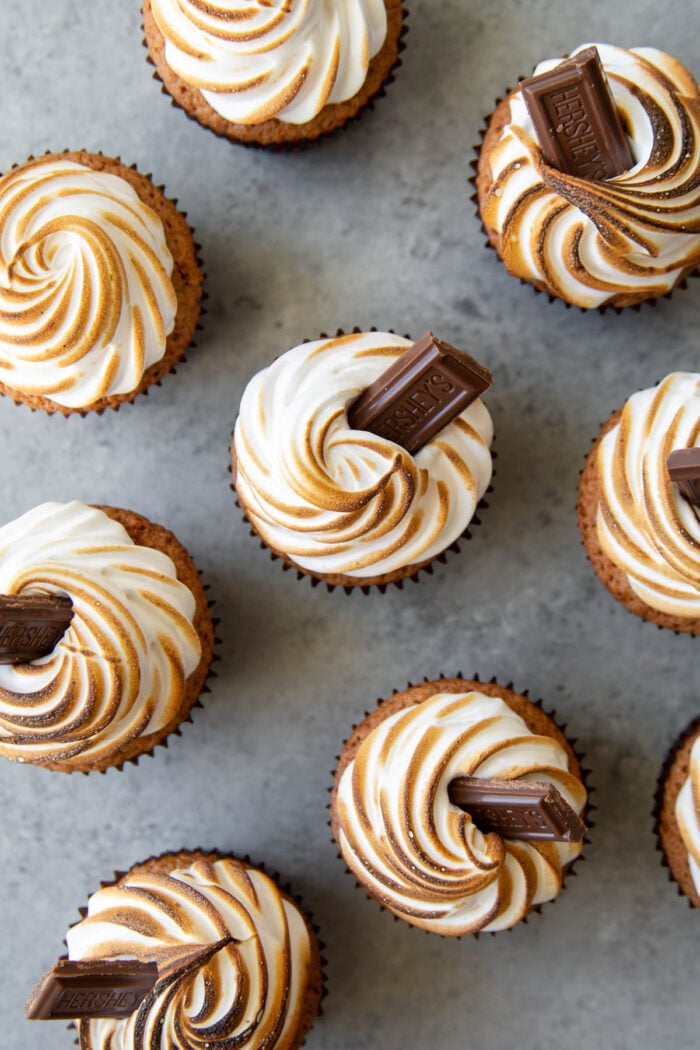 overhead of assembled s'mores cupcakes garnished with milk chocolate bar.