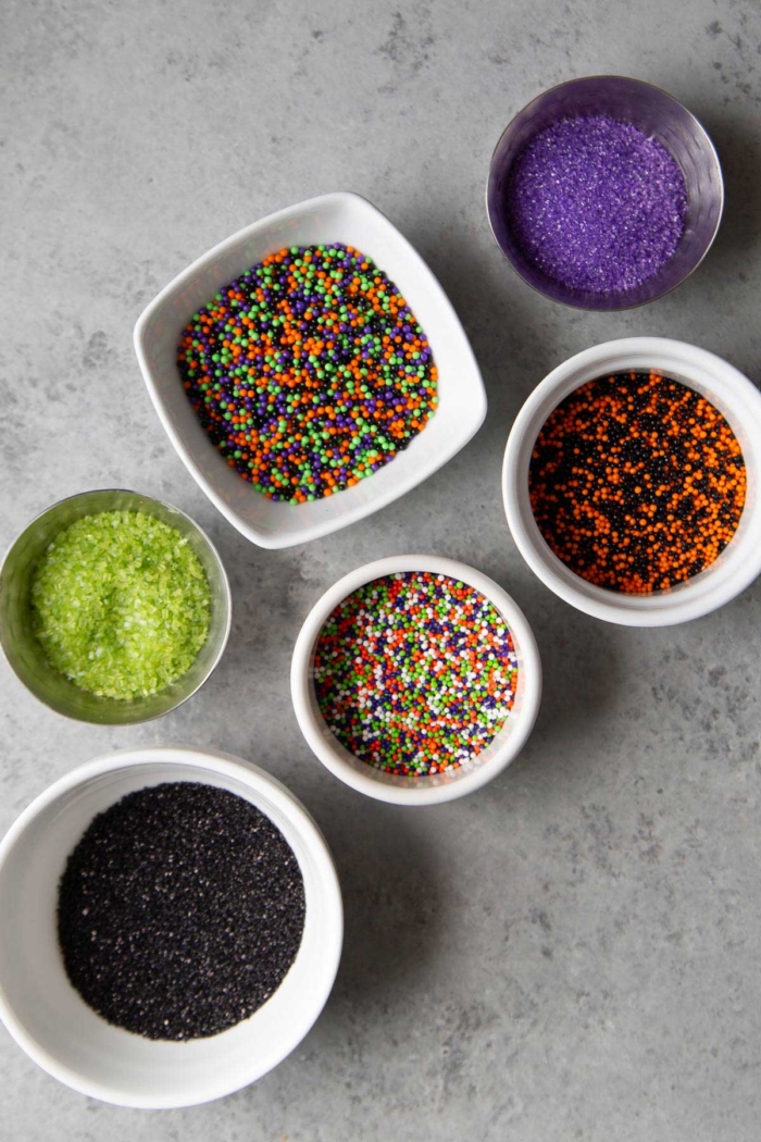variety of sprinkles and toppings to choose from for halloween donuts.