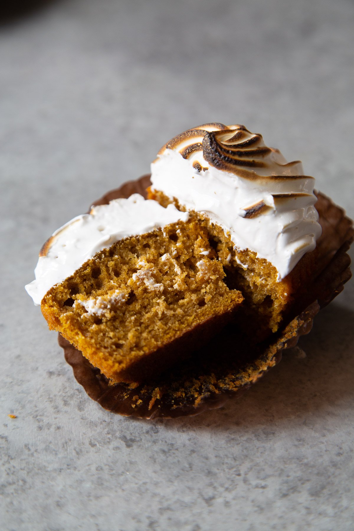 sweet potato cupcake cut in half to expose soft moist interior crumb.