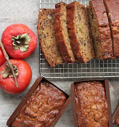 walnut persimmon cake cooling on rack.