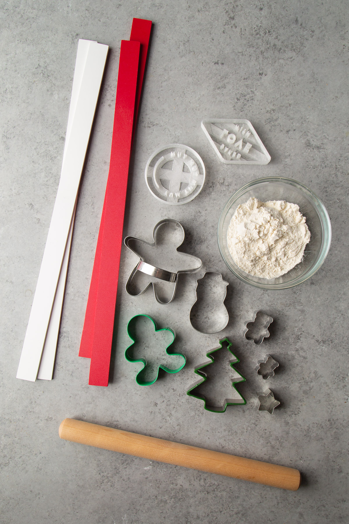 key tools for rolled out cookie dough include rolling pin, cookie stamps, and dough levels.