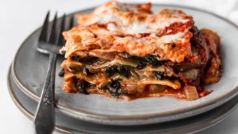 a serving of spinach mushroom lasagna on plate