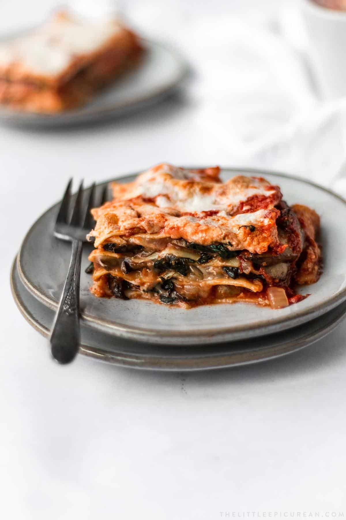 a serving of spinach mushroom lasagna on plate