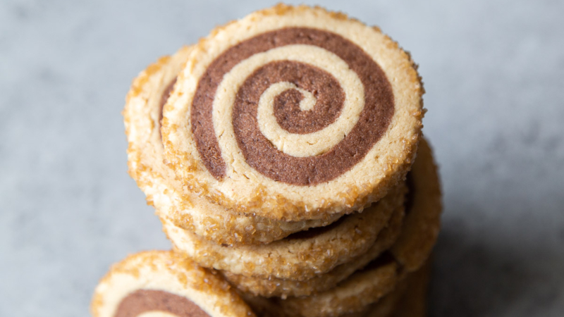 close up of stacked peanut butter chocolate pinwheel cookies.