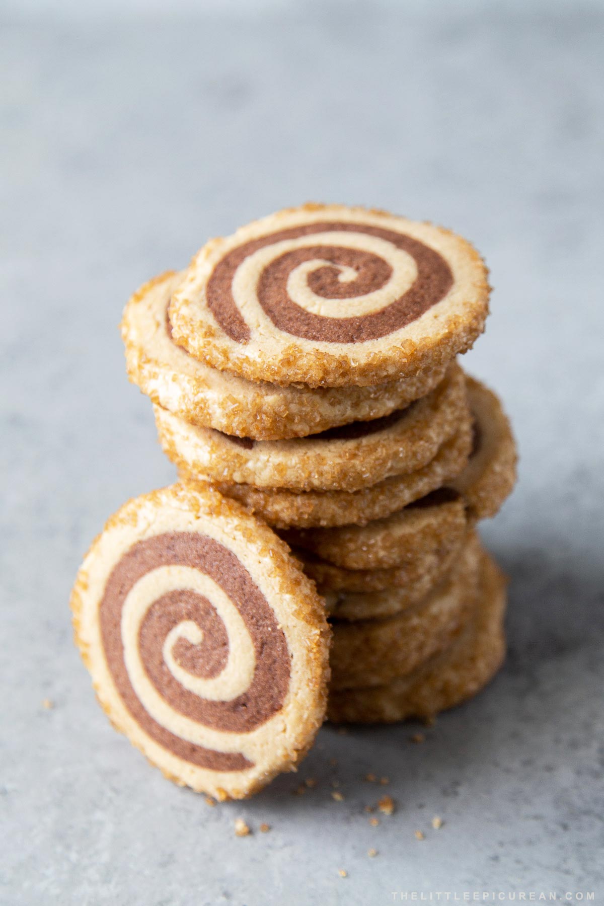 close up of stacked peanut butter chocolate pinwheel cookies with turbinado sugar coating.