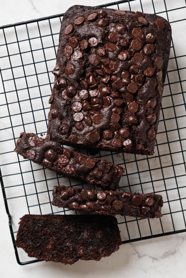 overhead view of double chocolate chip banana bread on black cooling rack.