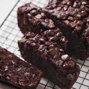 close up slices of chocolate chip banana bread on black cooling rack.