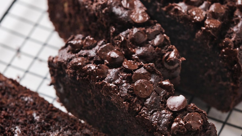 close up slices of chocolate chip banana bread on black cooling rack.