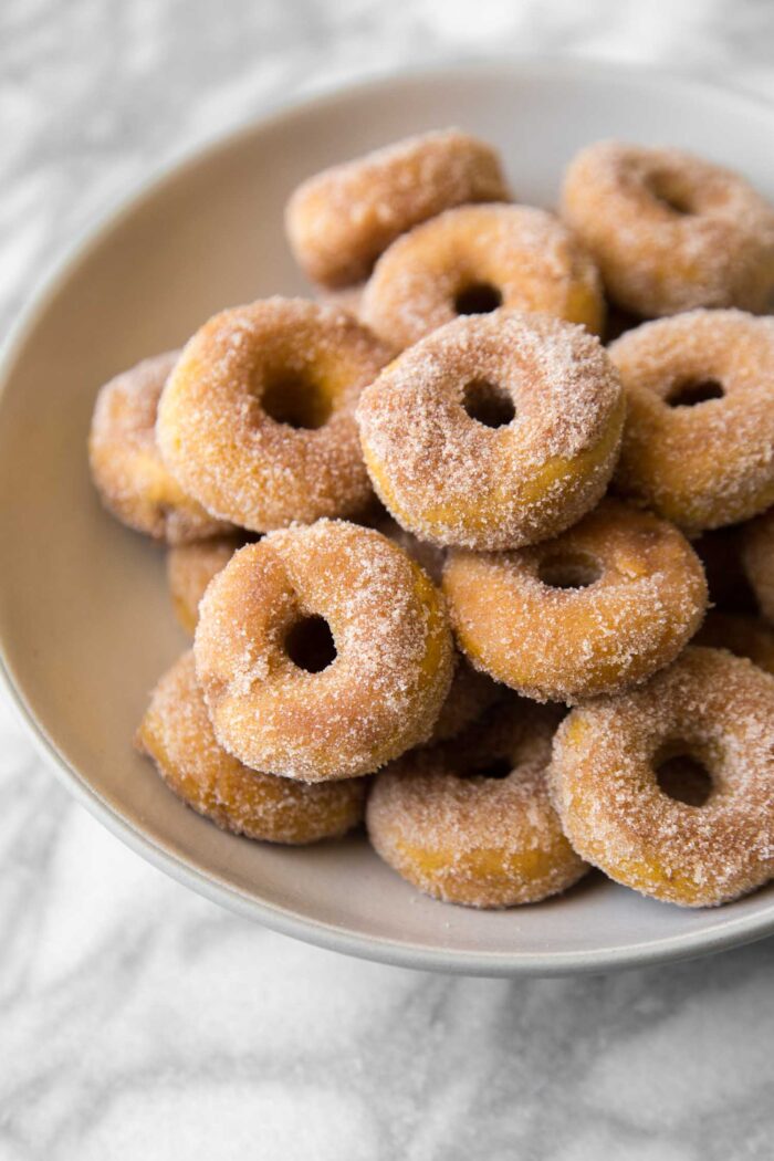 cinnamon sugar pumpkin donuts served on plate.