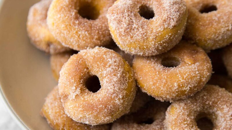 cinnamon sugar pumpkin donuts served on plate.