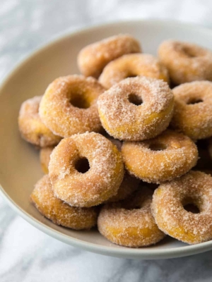 baked mini pumpkin donuts in serving bowl.