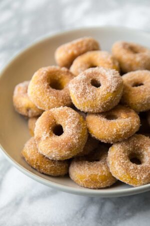 baked mini pumpkin donuts in serving bowl.