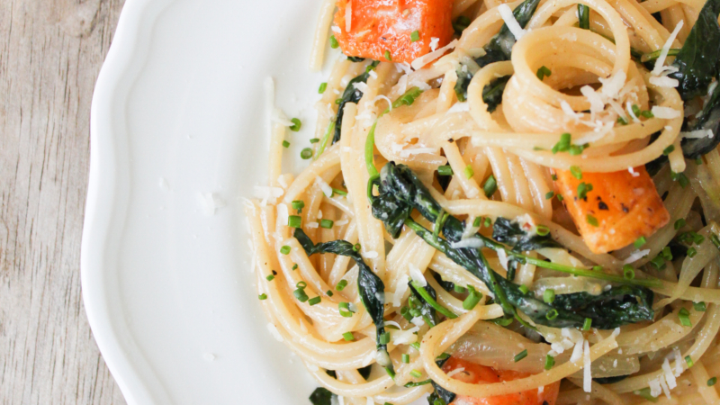 brown butter spaghetti with roasted butternut squash served on white plate.