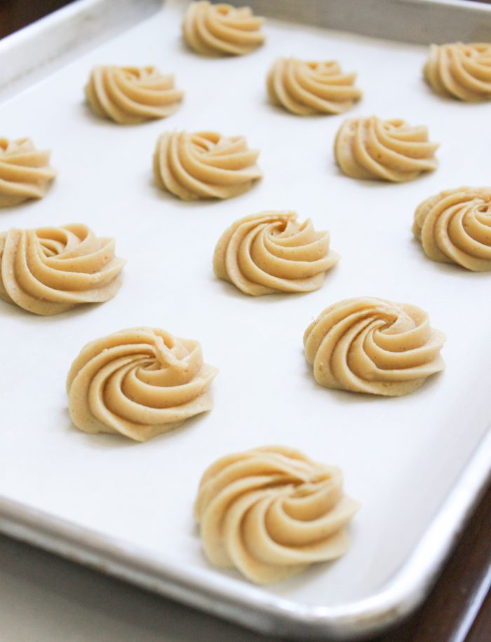 piped cookie batter of Vanilla Malt Cookies