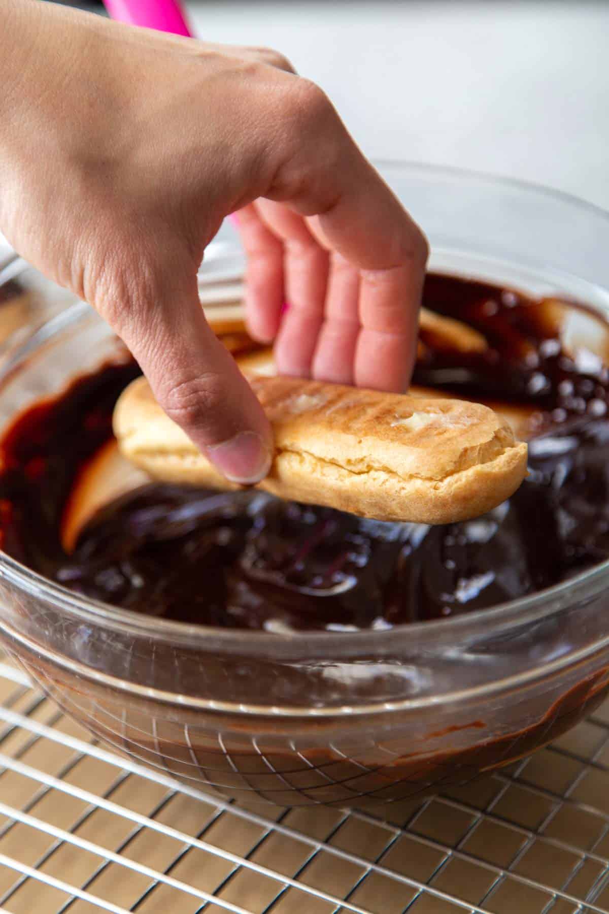 dip filled eclairs in melted chocolate.