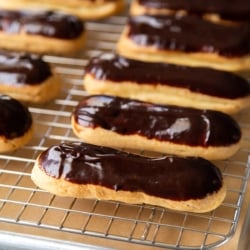 chocolate glazed eclairs on wire rack.