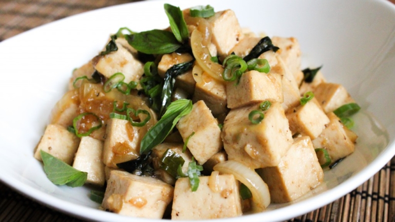 spicy basil tofu in a white serving dish.