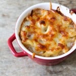 Italian mac and cheese baked in small red ramekin.