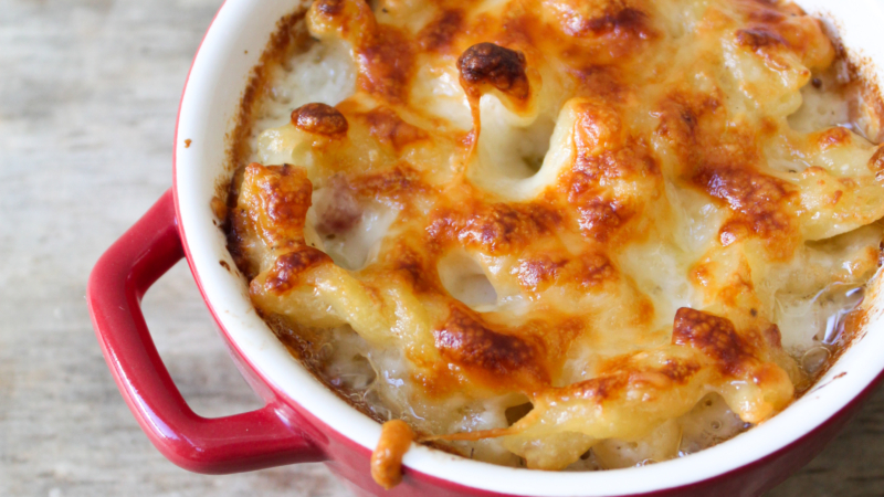 Italian mac and cheese baked in small red ramekin.