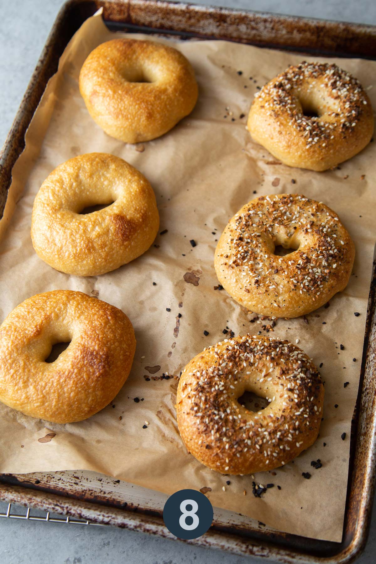 baked bagels on parchment lined sheet.