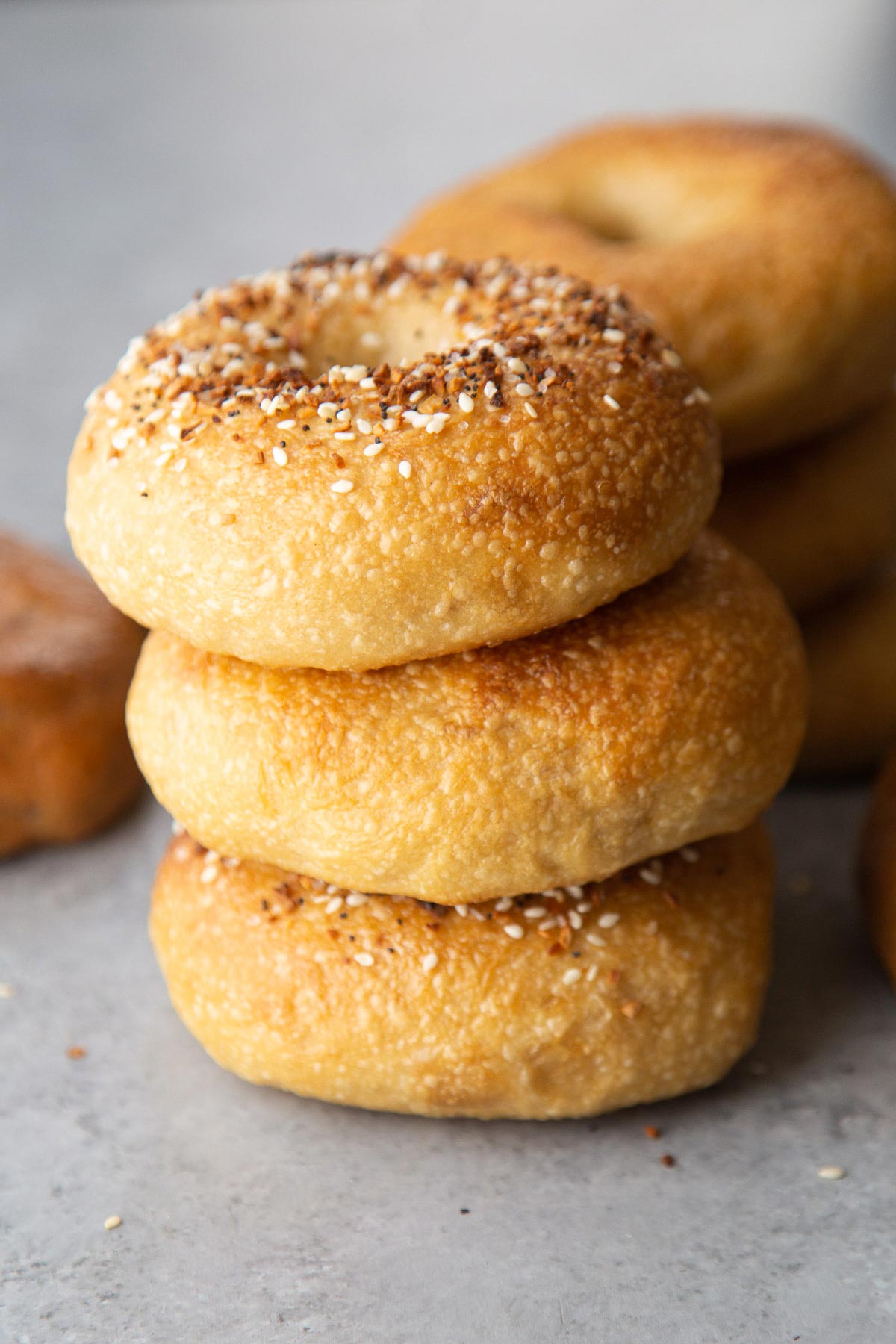 three everything seasoning bagels stacked up.