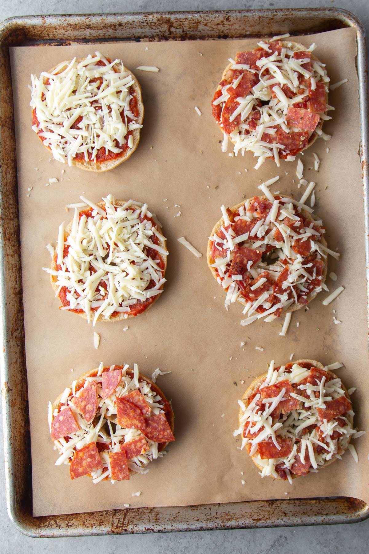 assembled pizza bagels ready to be frozen.
