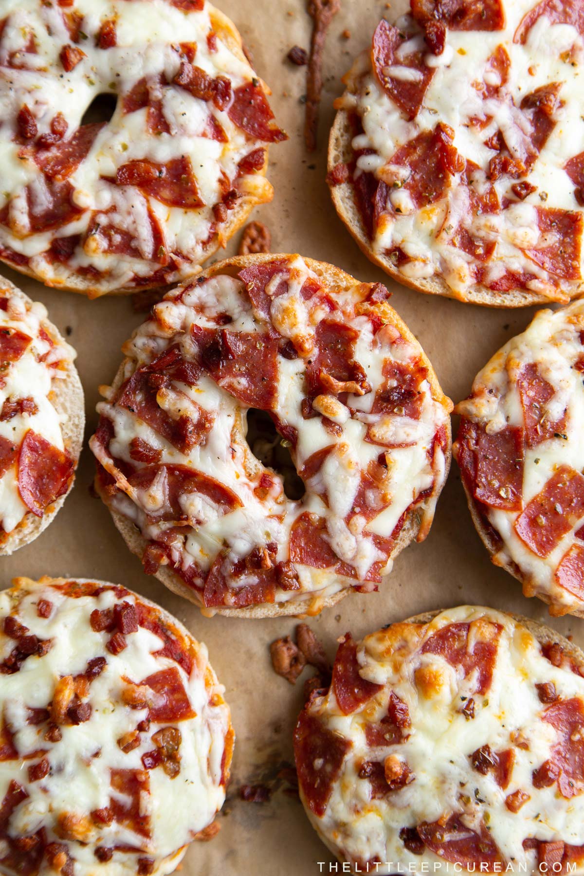 homemade pizza bagels topped with sauce, cheese, pepperoni, and pancetta.