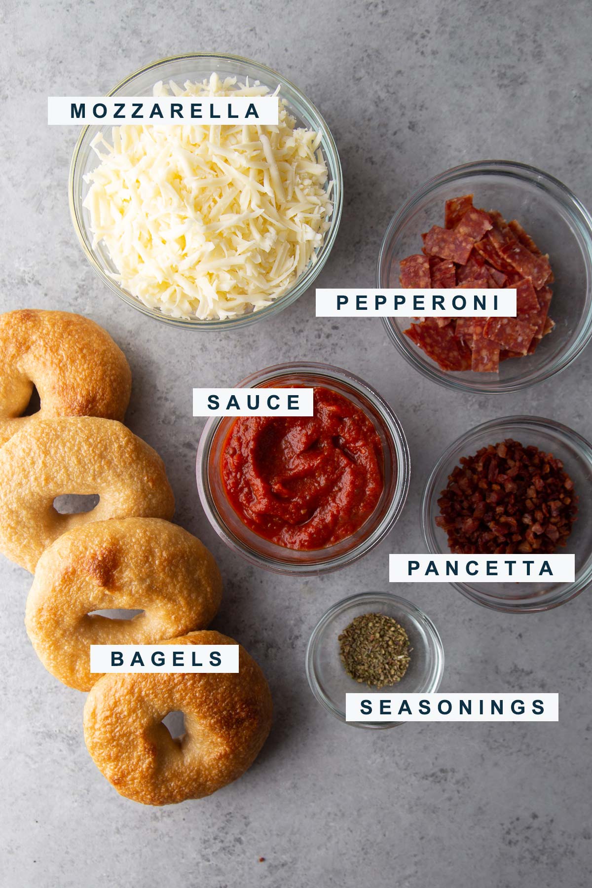 pizza bagel components are bagels, mozzarella cheese, sauce, and pepperoni.