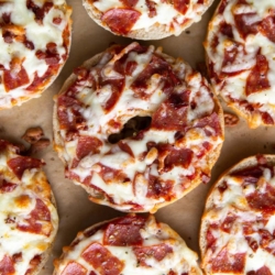 homemade pizza bagels topped with sauce, cheese, pepperoni, and pancetta.