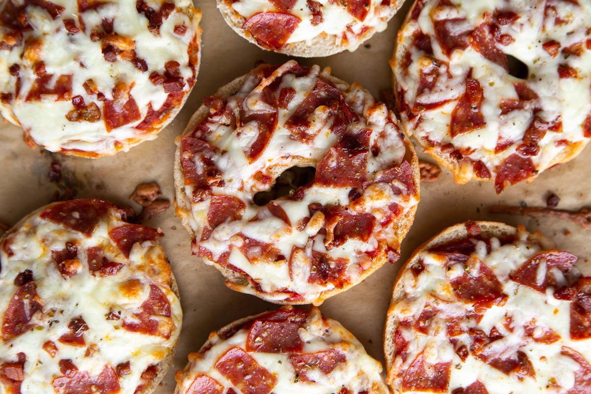 homemade pizza bagels topped with sauce, cheese, pepperoni, and pancetta.