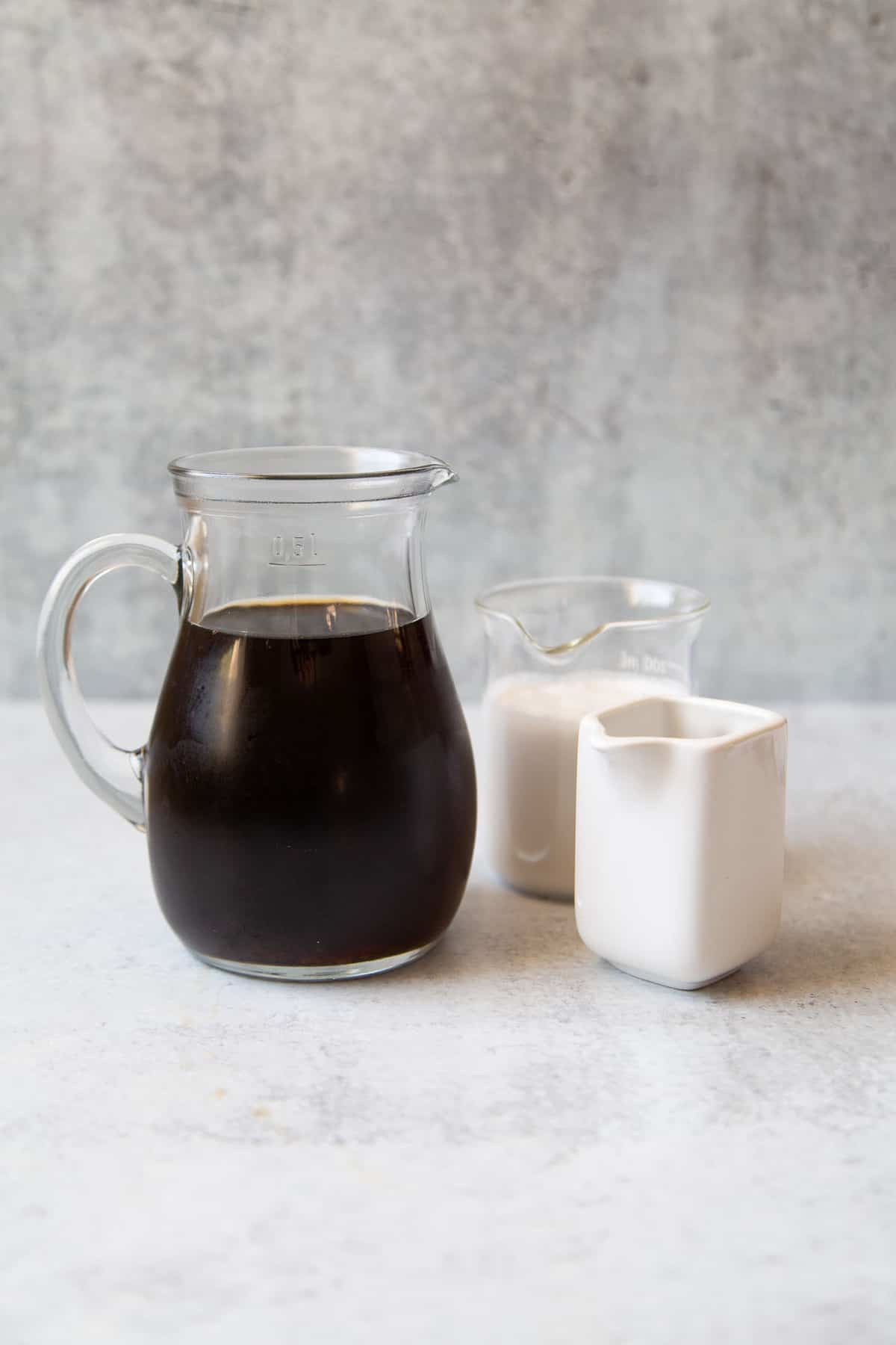 cold brew coffee, milk, and simple syrup portioned out. 
