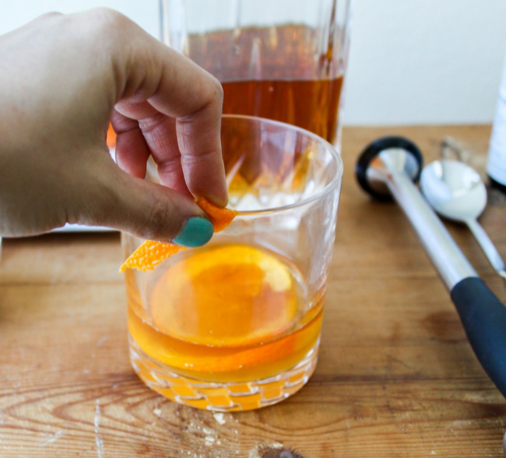 rub orange peel around rim of glass