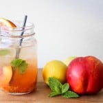 nectarine smash cocktail served in mason jar along side fresh fruit.