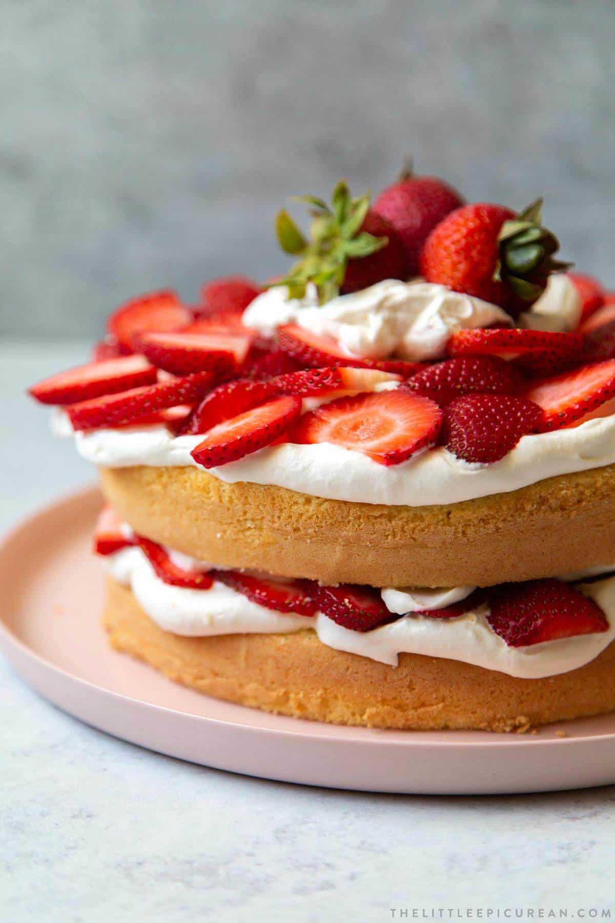 sponge cake with whipped cream and fresh strawberries.