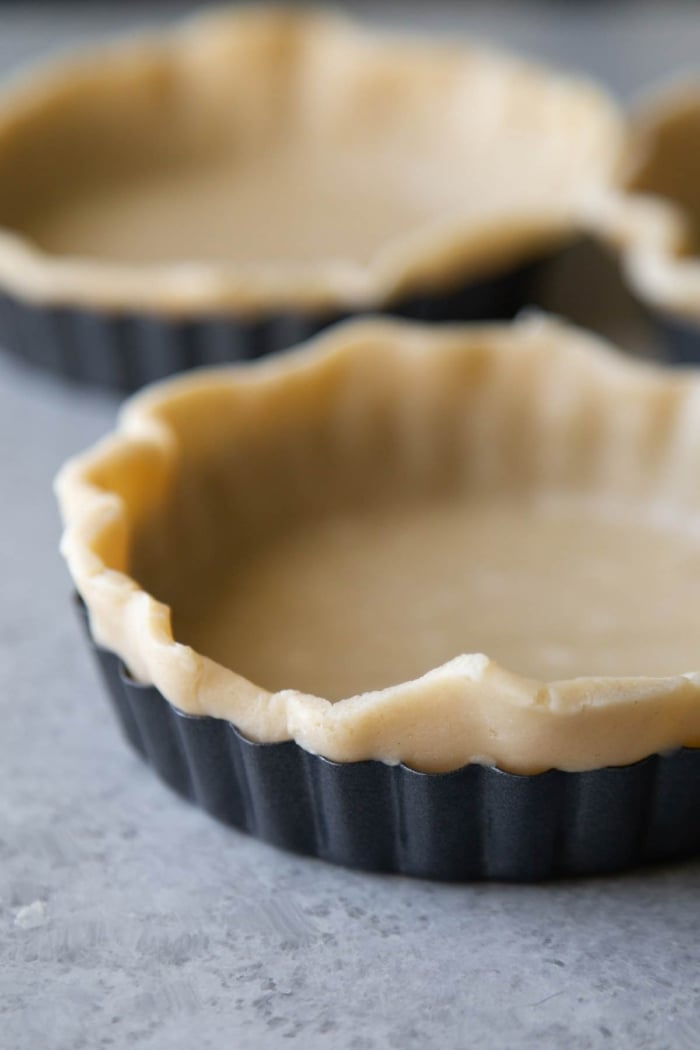 press pie dough up against edges of tart shell.