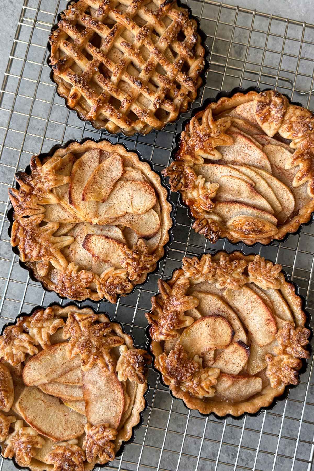 mini apple pie tarts cooling on wire rack.