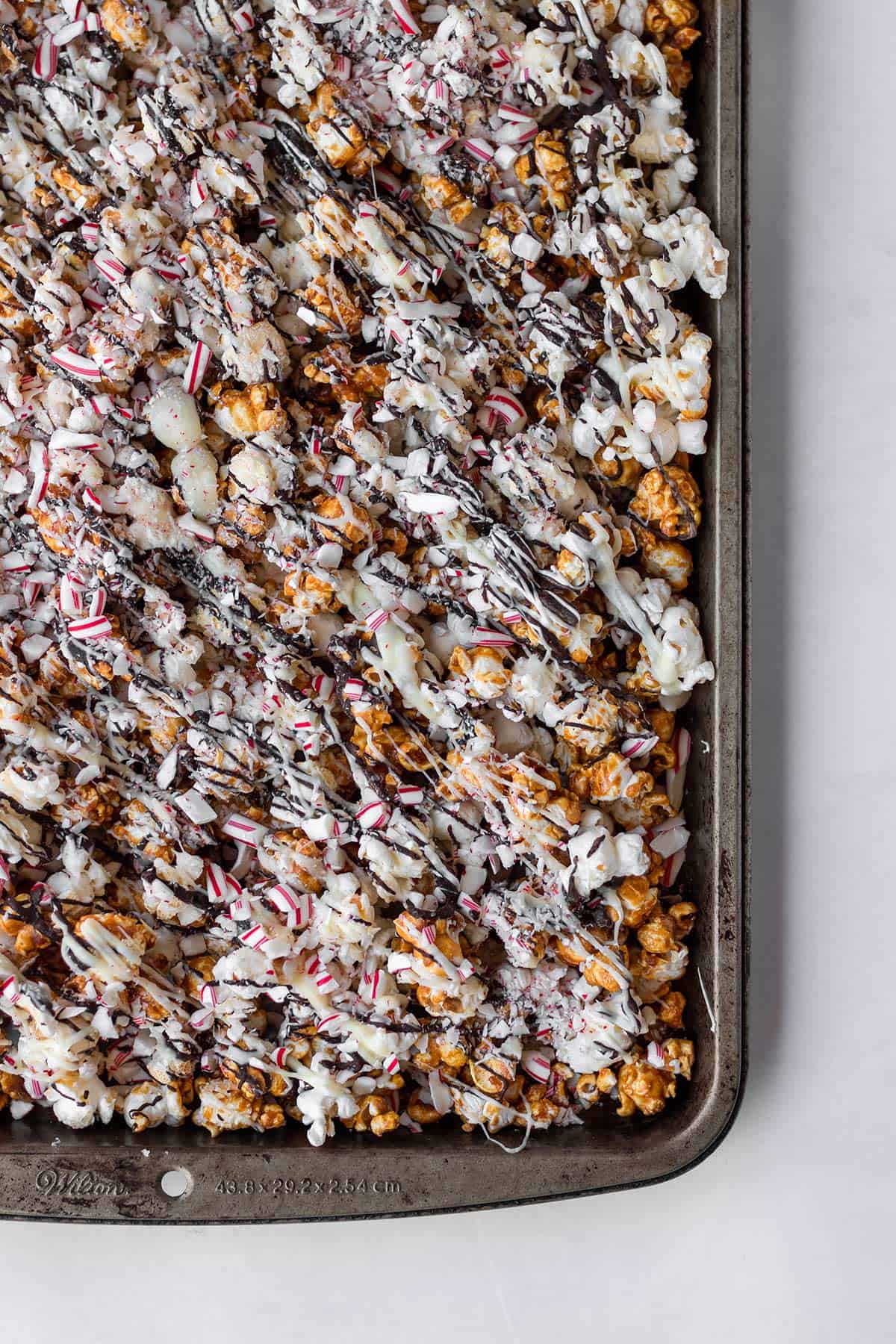 peppermint bark caramel popcorn in sheet pan