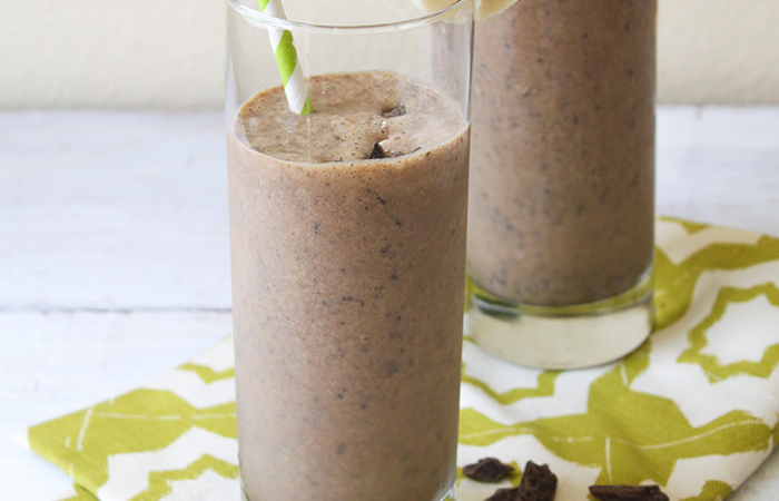 chocolate peanut butter banana smoothie with espresso in glasses with paper straws.