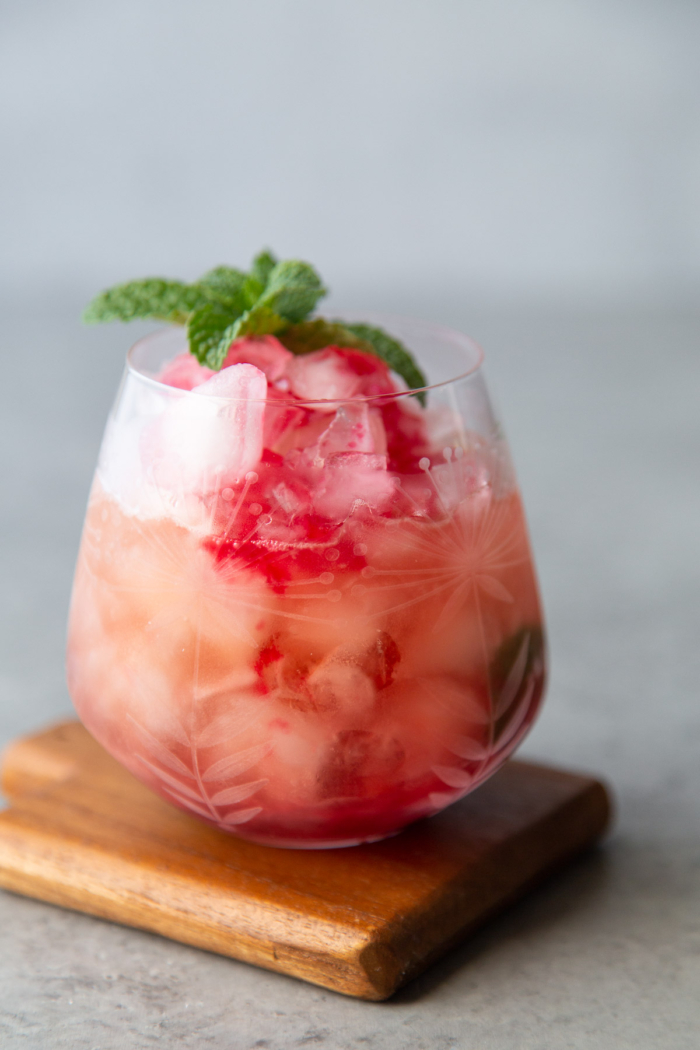 cranberry mint julep garnished with fresh mint in highball glass.