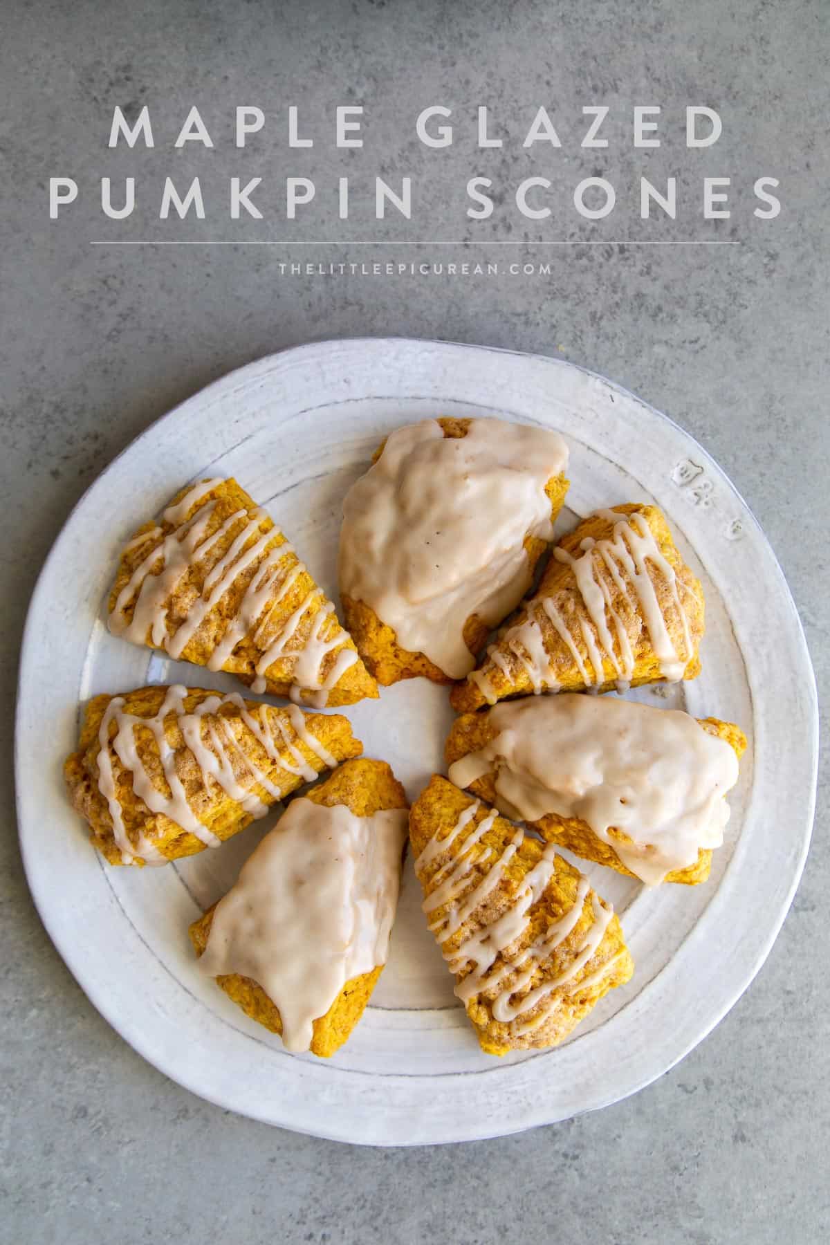 maple glazed pumpkin scone wedges arranged in a circle on serving plate.