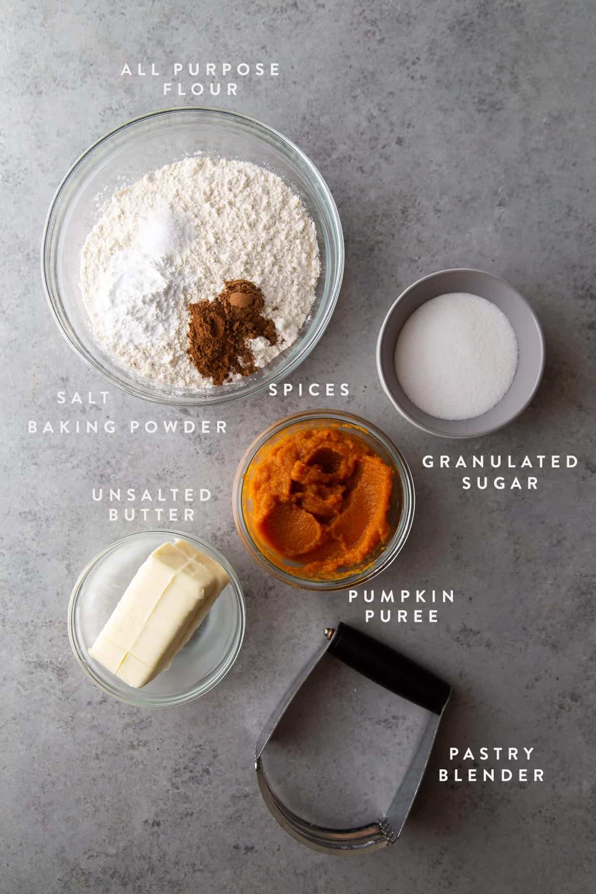 pumpkin scone ingredients including pumpkin puree, butter, sugar, and flour.