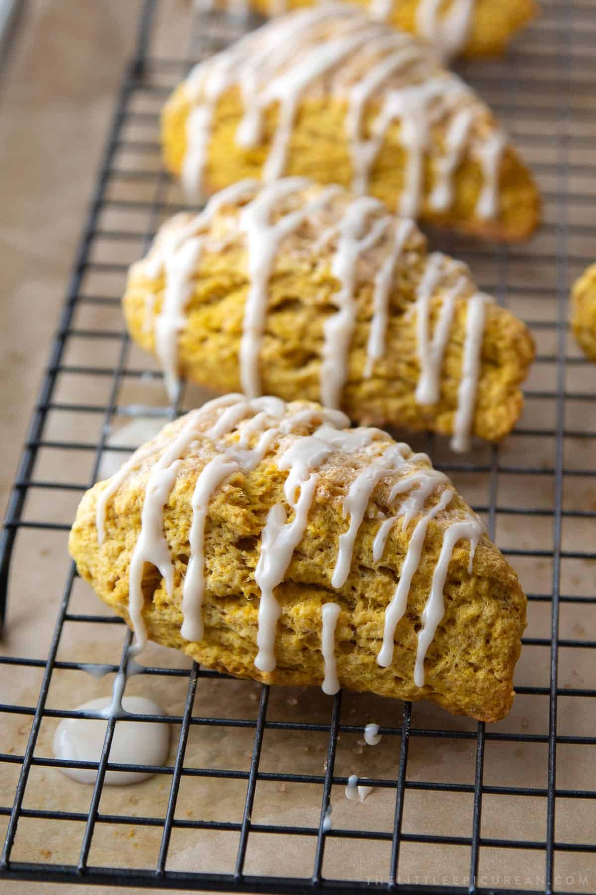 maple glazed pumpkin scones on black wire rack.